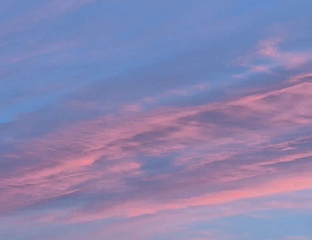Picture of some pink clouds against a bluesky at sunset 