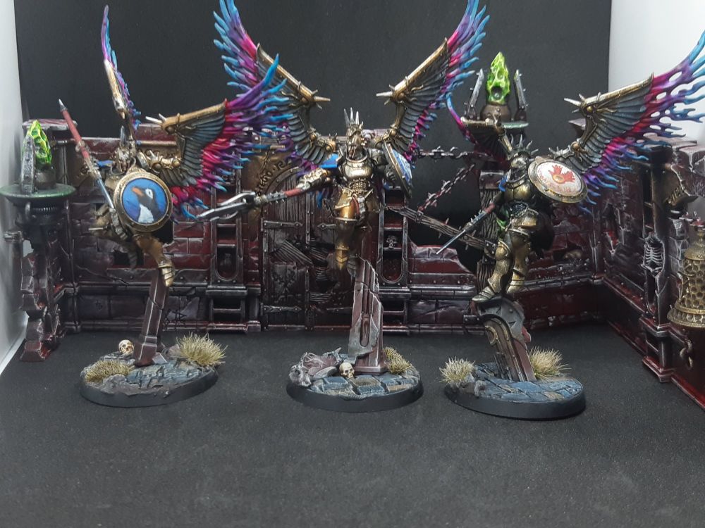 Three Prosecutors, resplendent in gleaming armour and blazing wings