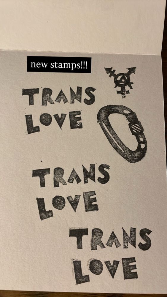 linocut print “trans love”, carabiner, circle a trans symbol 