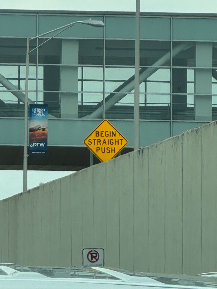 A street sign that says “BEGIN STRAIGHT PUSH”