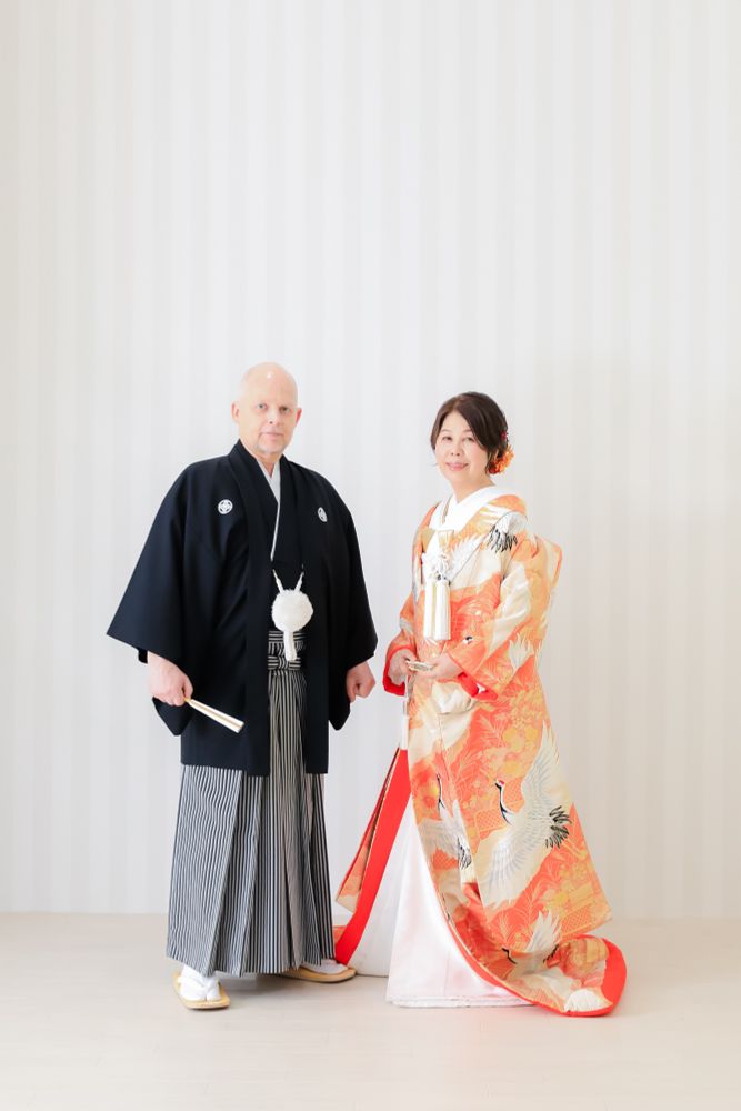 Full-length portrait of a man and woman in Japanese wedding attire