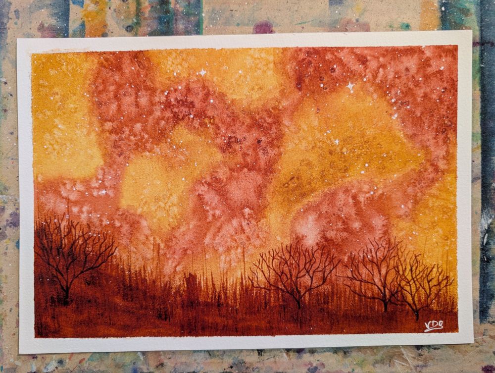 A watercolor painting of a swirling orange and ochre sky, with a foreground of dry bushes and grasses in a reddish brown earth. 