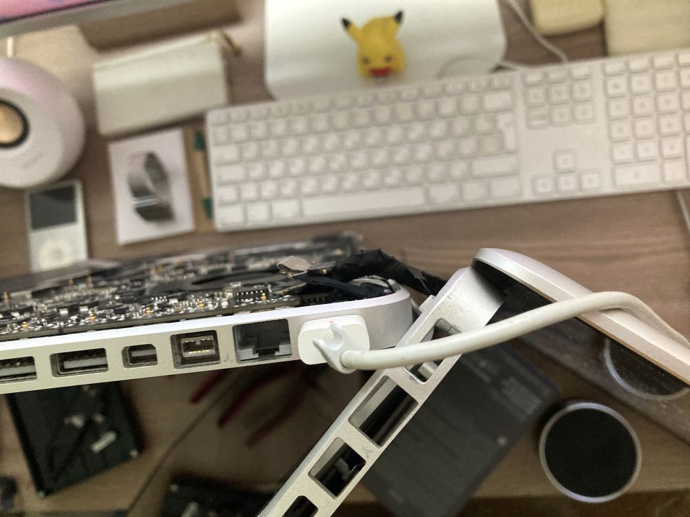 Close up of the MacBooks showing that the display of one is connected to the logic board of the other