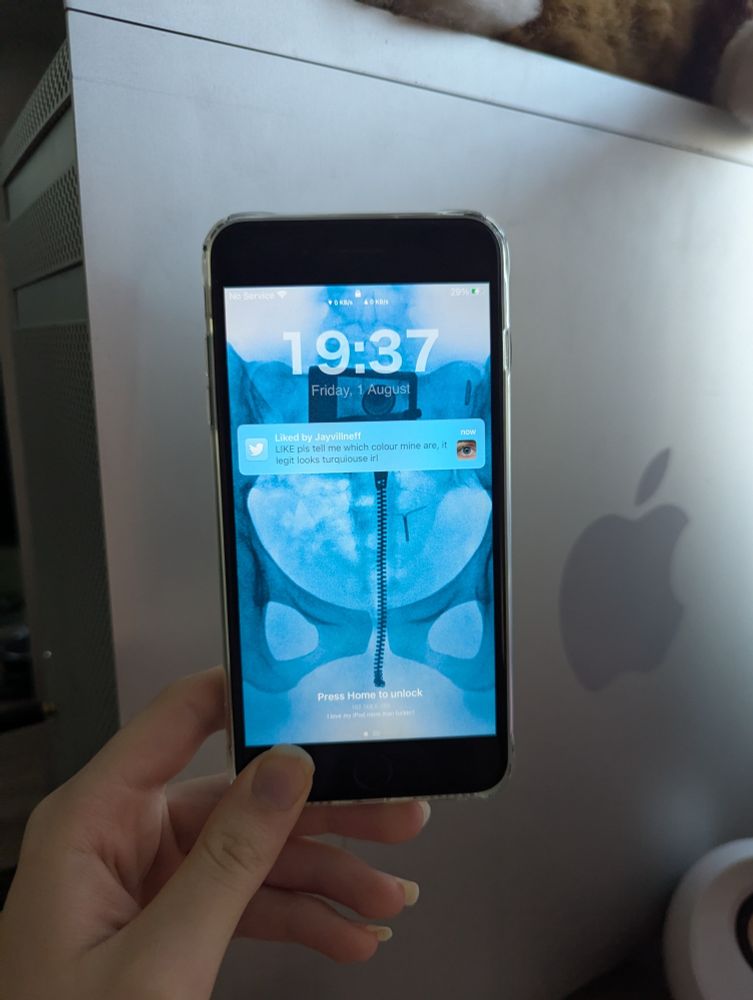 Pic of me holding up an iPhone 7 Plus on the lock screen