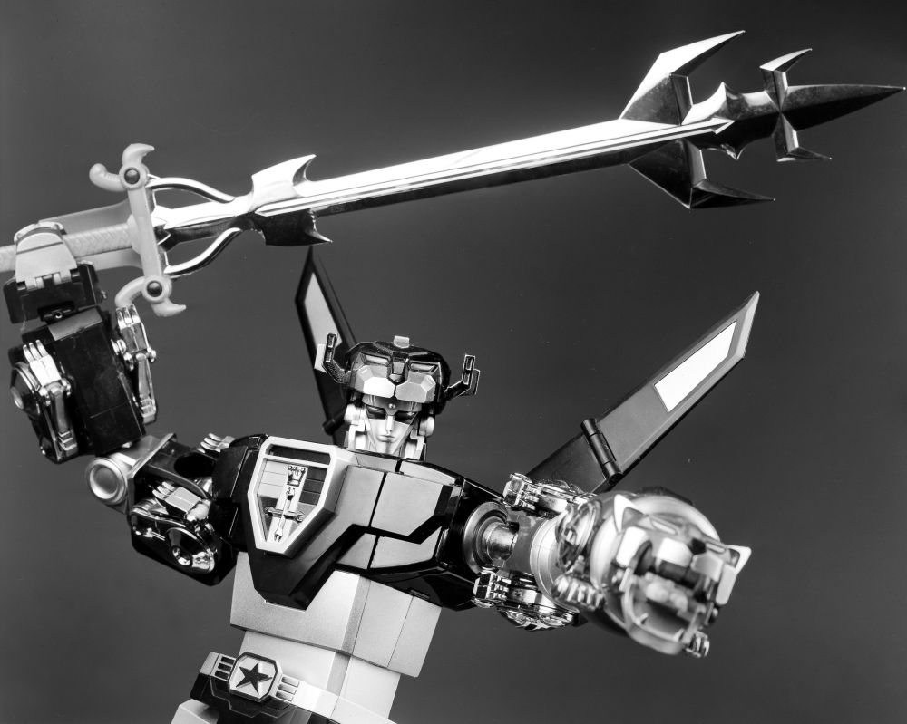A black-and-white photo of a toy of Voltron: Defender of the Universe.