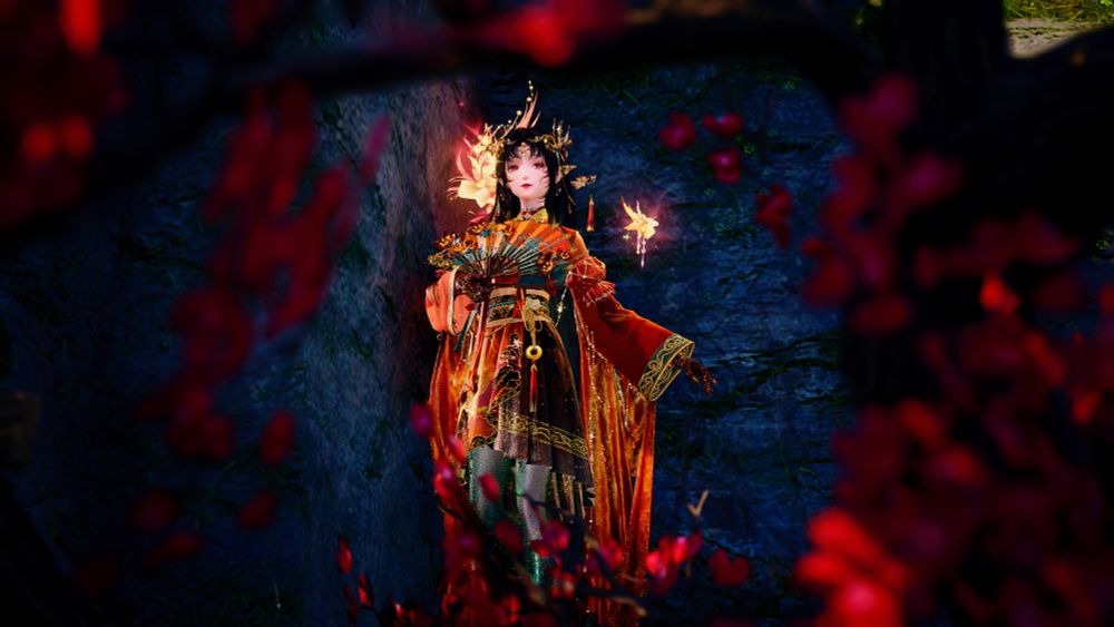 A dark haired woman in red Chinese style silks, amid red leaves.