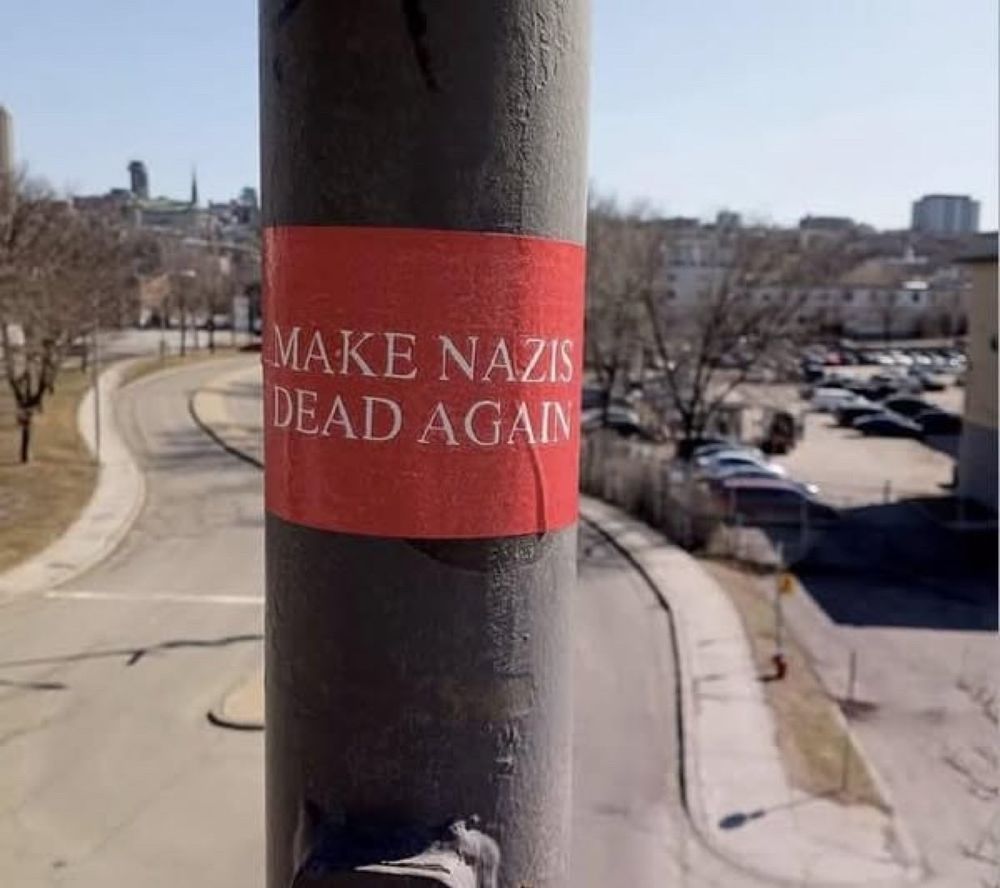 A sign that says “make Nazis dead again”