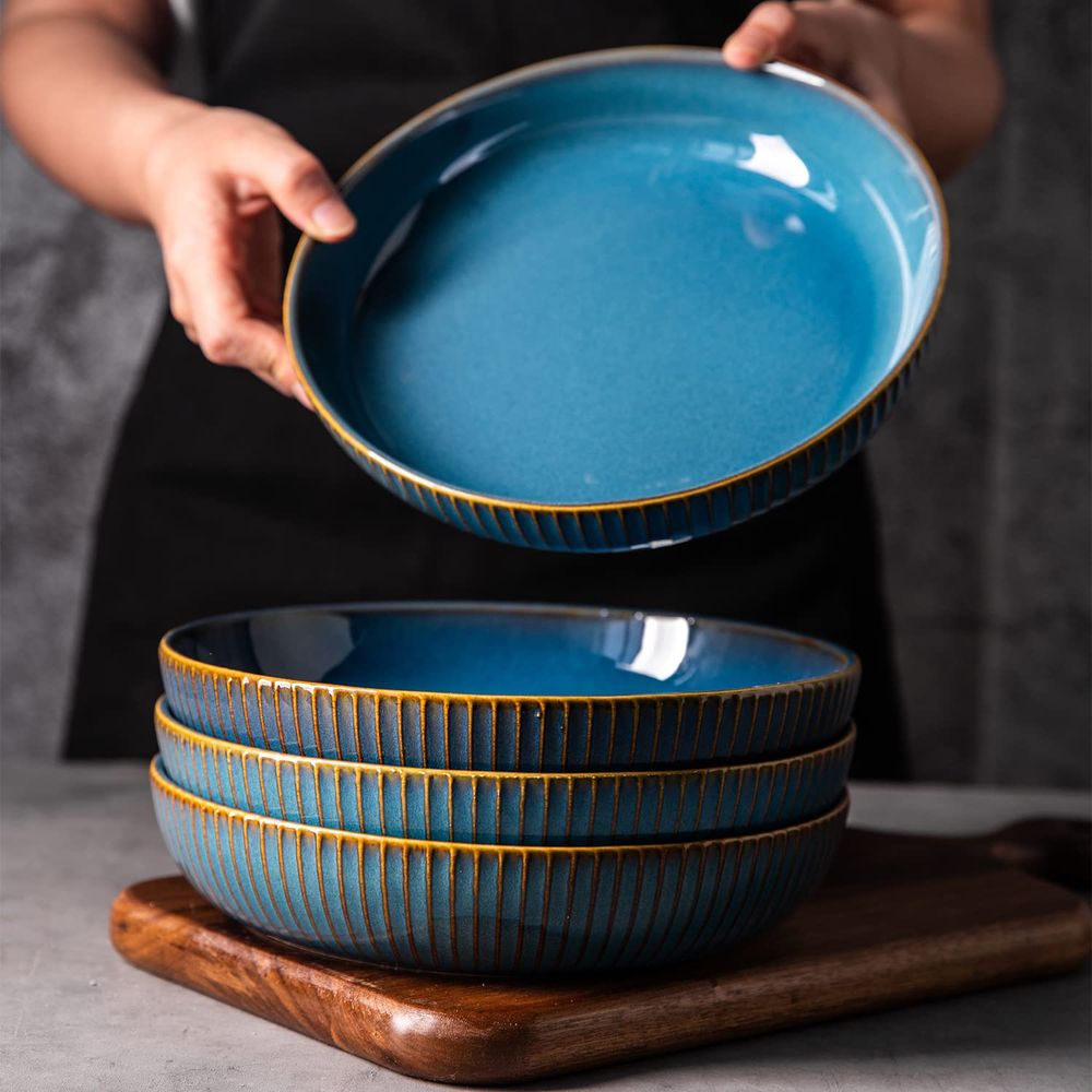 A stack of blue bowl plates with a golden rim.