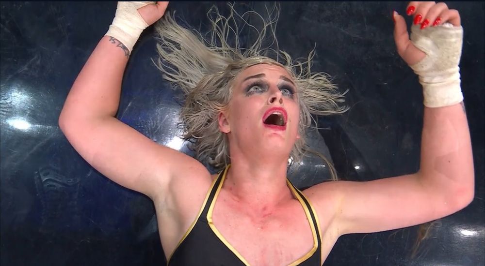 Toni Storm lying on ground exhausted.