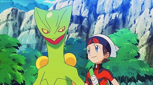 a boy is standing next to a green pokemon in a cartoon .