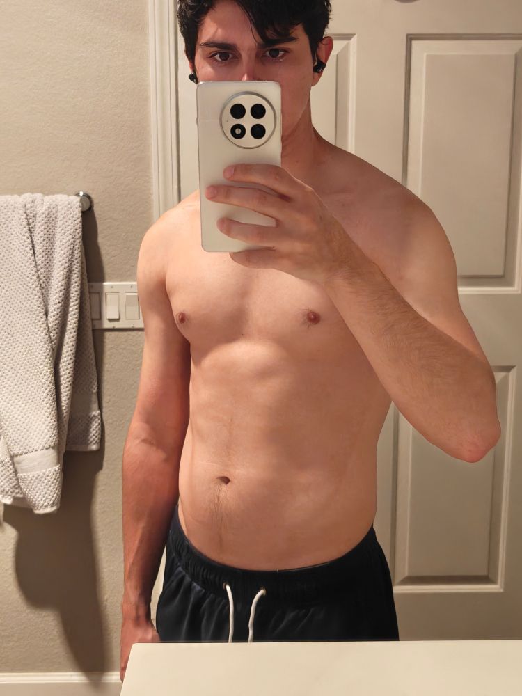 me shirtless in my bathroom mirror at a slight angle