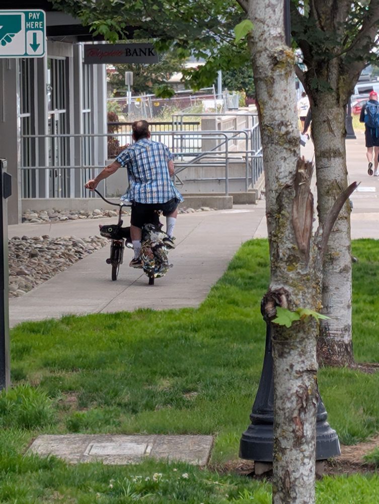 slimm riding away on the rat bike