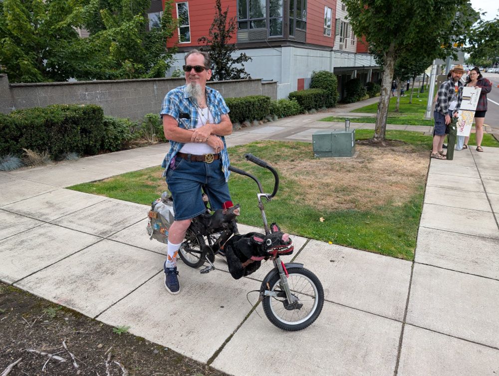 slimm buick on a swing bike adorned with rats