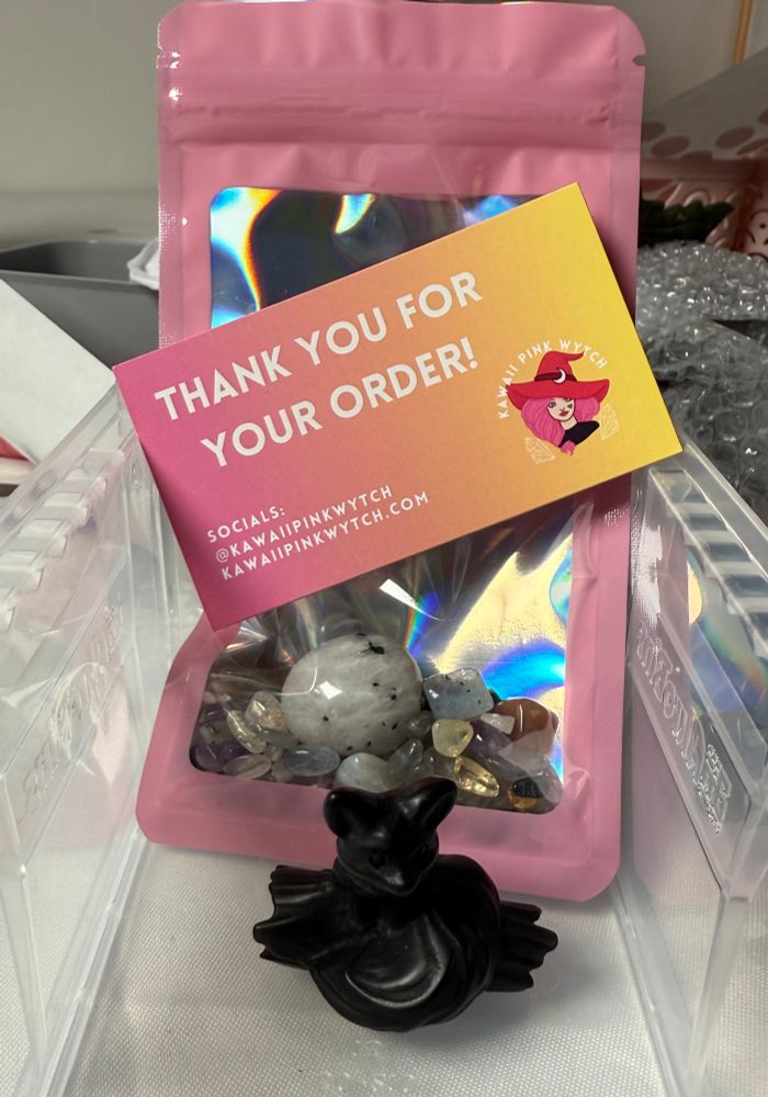 Order with an obsidian fox on a log, crystal confetti scoop and business card