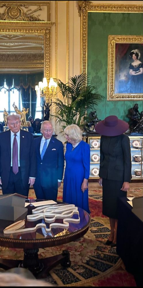 King Charles and Queen Camilla are pictured talking while standing in a group with the Trumps. 