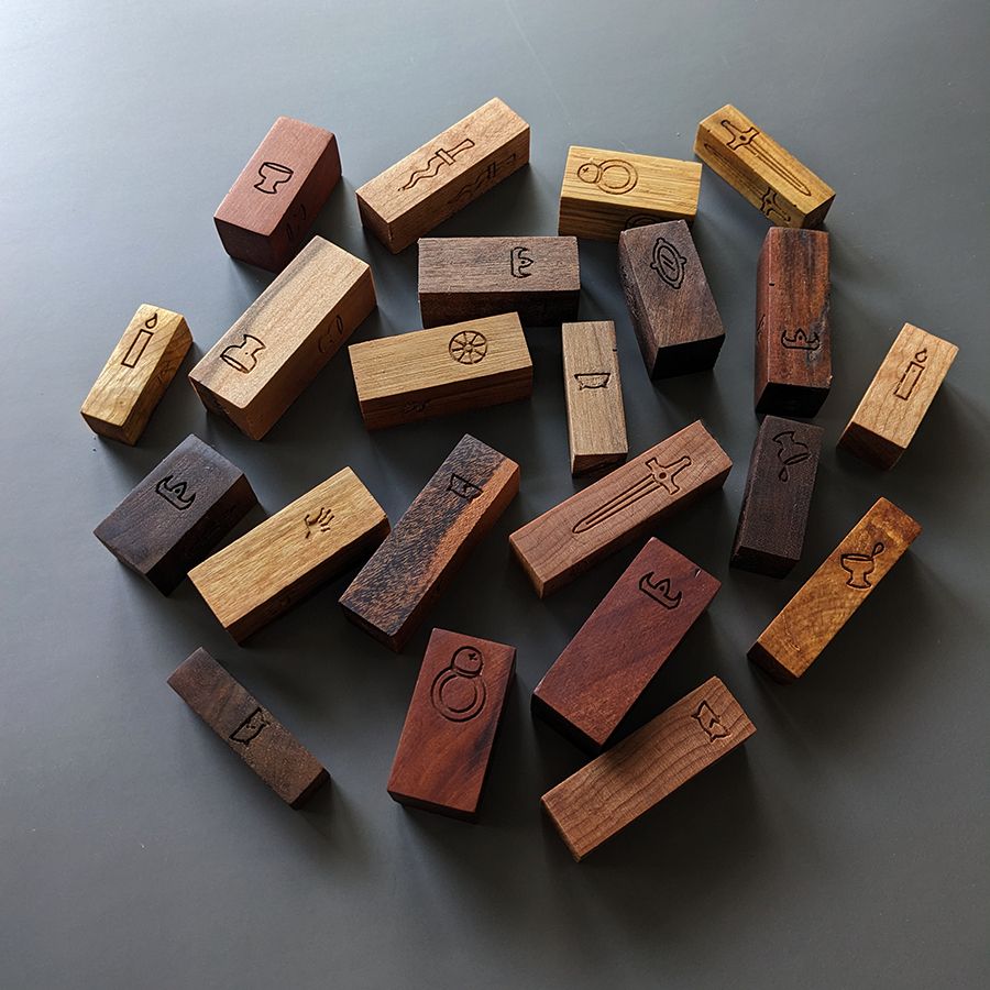 pile of wooden hexahedrons with various mysterious glyphs engraved upon their 4 primary faces