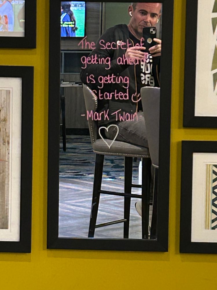 A mark twain quote written on a mirror in bar for reasons best known to the owner of the mirror. Also me, but only in reflection (actual reflection) 
