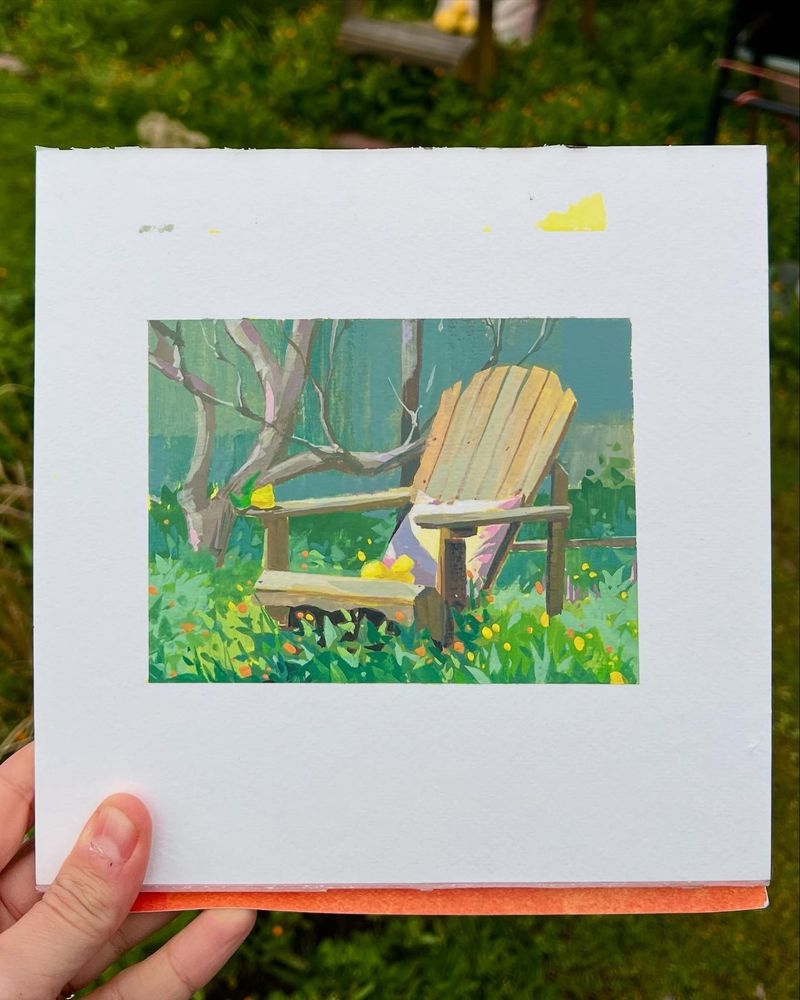 A painting of lemons atop a wooden chair in a garden surrounded by orange and yellow flowers.