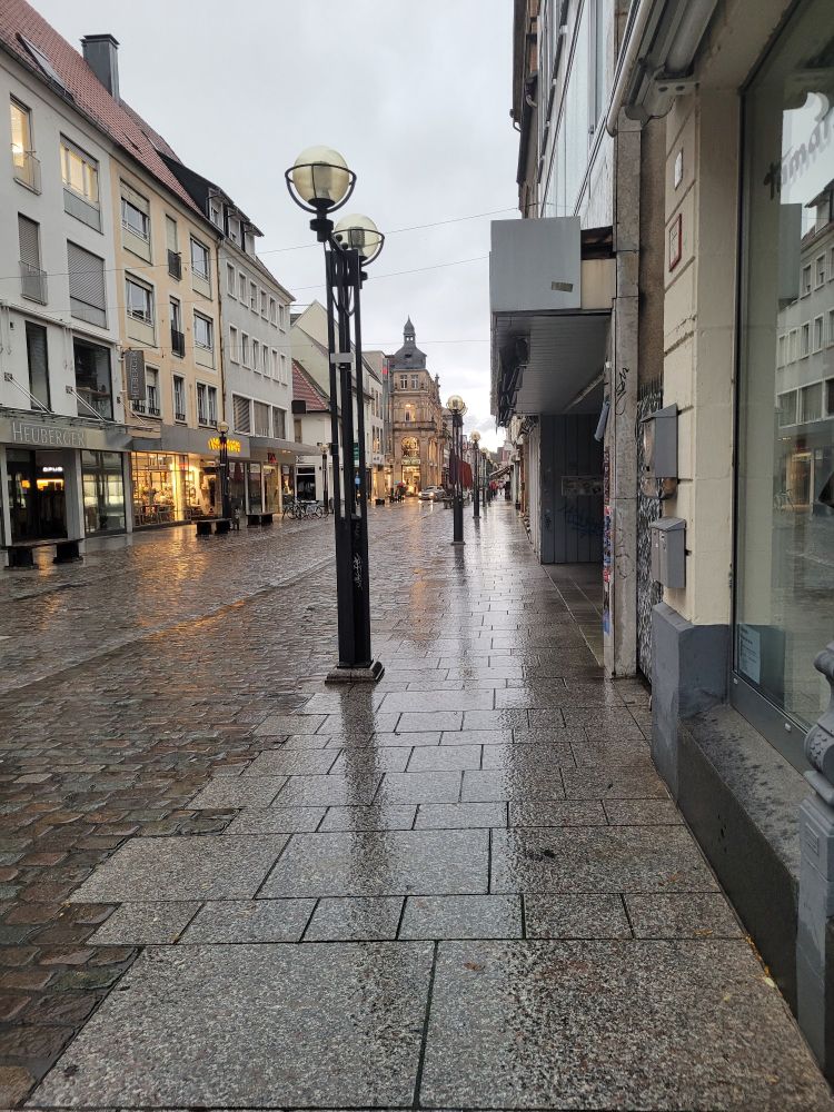 A picture looking down Marktstraße towards the square, the main shopping street in Landau. It's rainy and dark and there's almost no one else around
