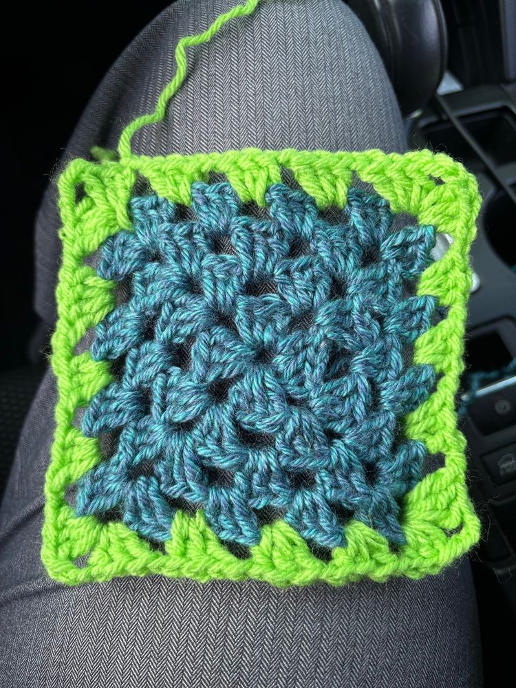 Blue granny square with a lime green border 