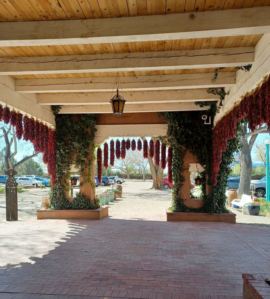 Large entrance arch of El Pinto restaurant in Albuquerque, NM, hung with ristras (a string of dried red chiles)