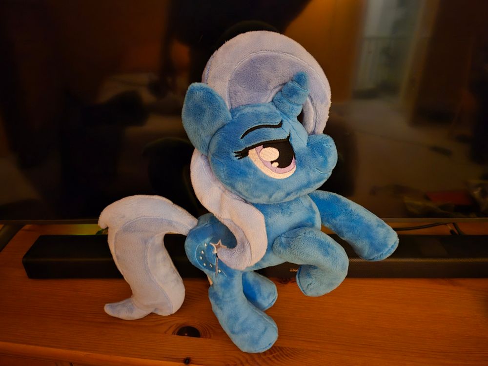 A Trixie lulamoon plush rearing up and kicking the air in front of her