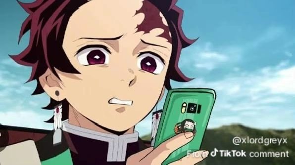 Tanjiro from demon slayer cringing at a smartphone 