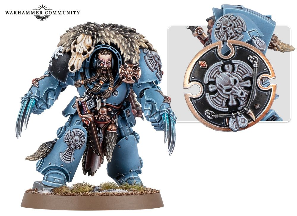 A photo of a Warhammer 40,000 miniature. It is a Wolf Guard Terminator, a space marine in heavy armor from the Space Wolves chapter. The armor has large power fists with claws and wolf-themed decorations, including a wolf skull and pelt hanging over the shoulders.