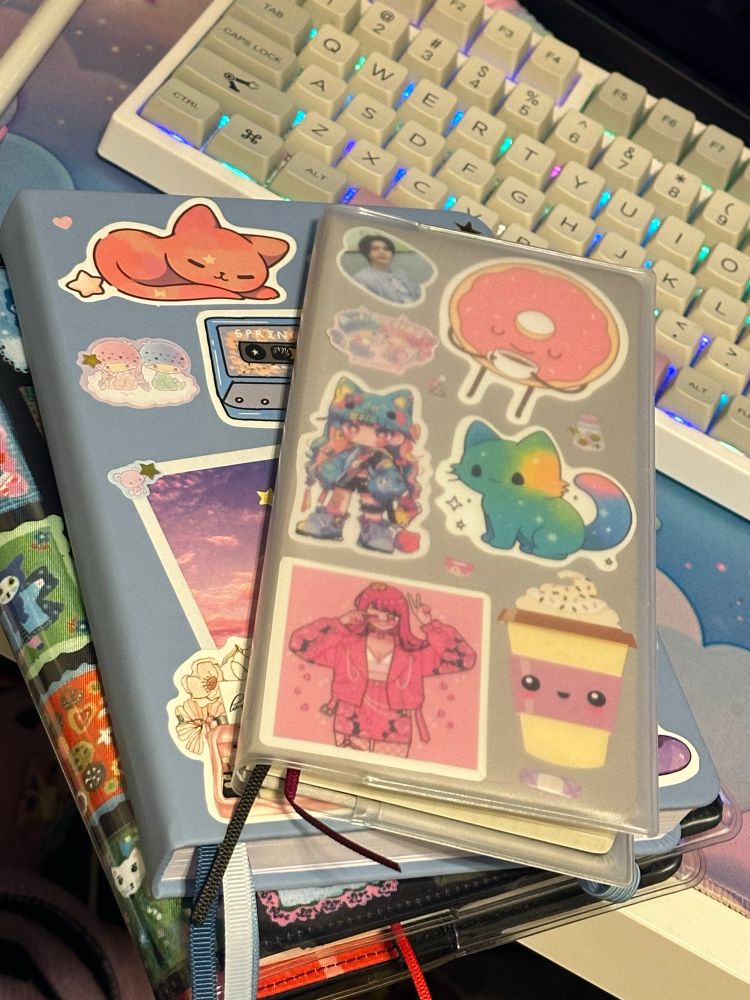 Three journals of various sizes decorated with stickers. 