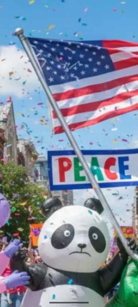 AI slop picture. Traumatized looking inflatable panda bear is "holding" an American flag with the wrong number of stars and stripes. Is the flag even connected properly to the pole?!