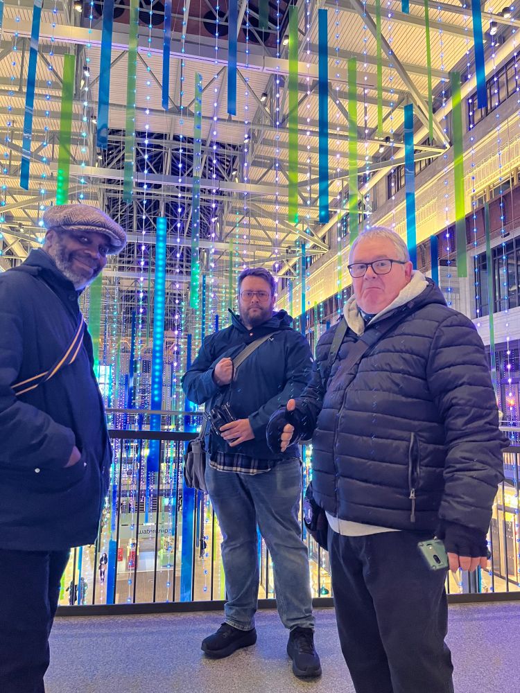 Posed iPhone photo of three participants of the photo walk in front of a light festival installation inside Battersea Power Station shopping mall. 