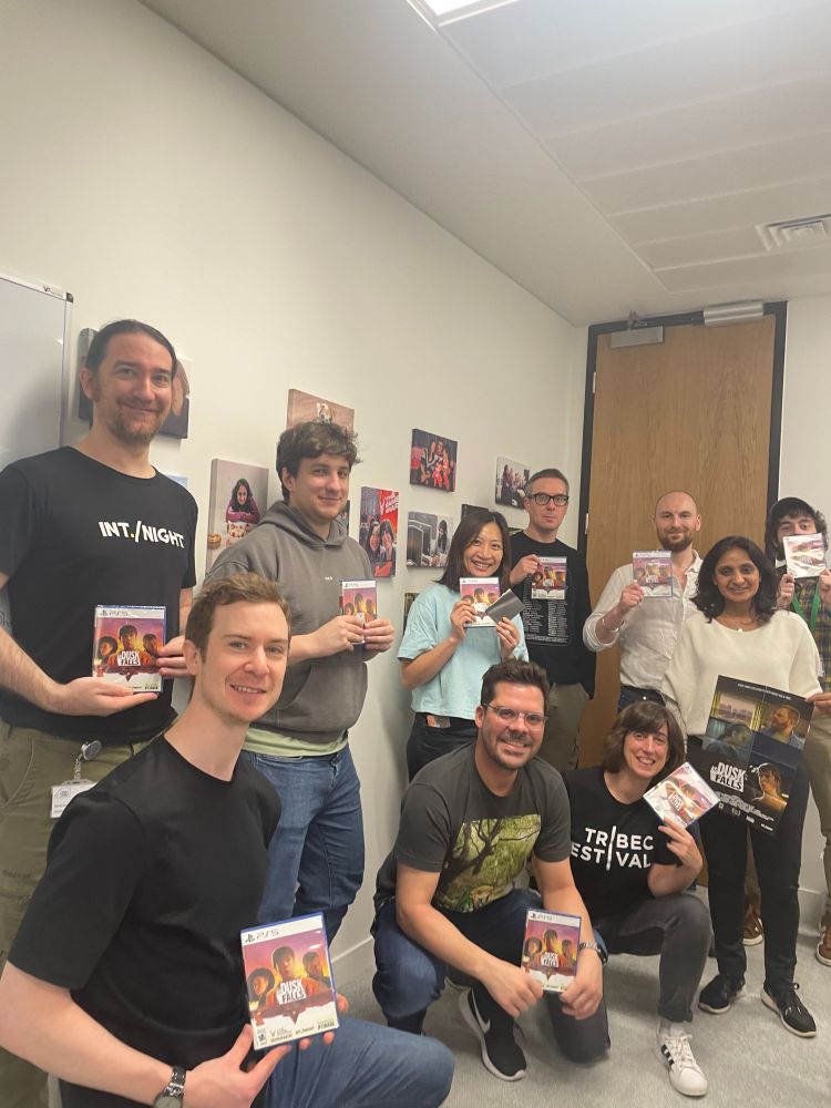 Team holding up their physical copies