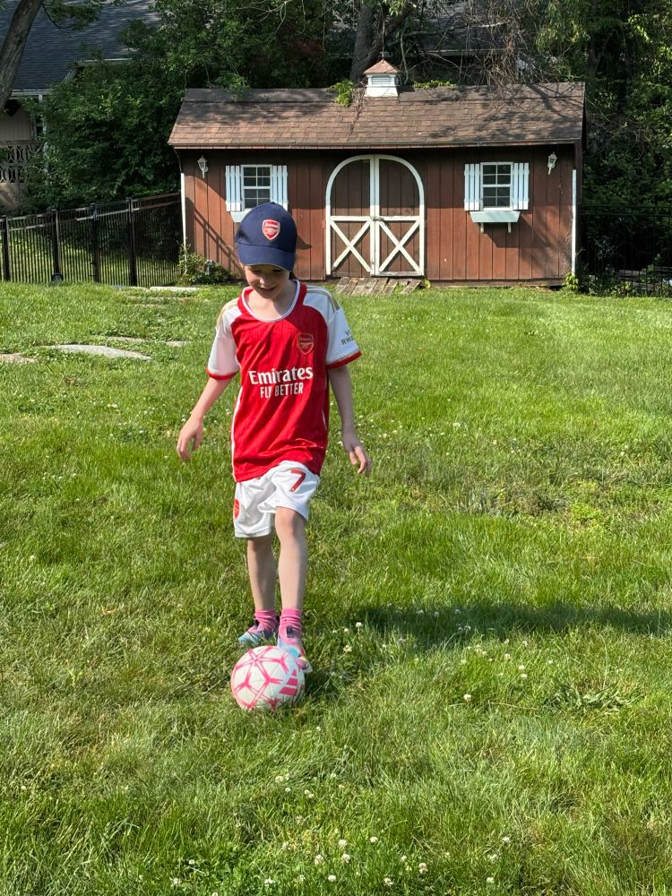 My daughter practicing soccer in her Saka jersey 