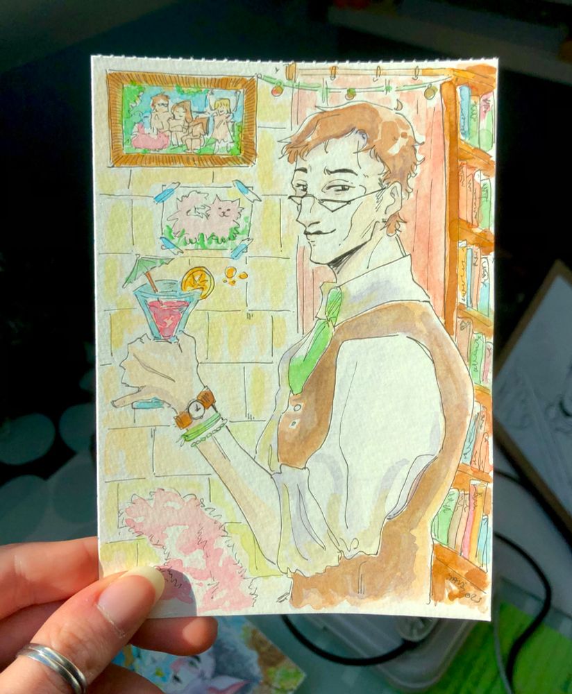 An A6 format watercolor with bright colors featuring Corin, a friend's OC (@/jen_ae_ on ig). He wearing a suit, and holding a drink in front of his bookshelves. Family pictures can be seen hanging on the walls behind him.