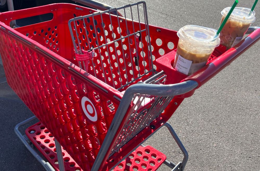 An image of a red target cart with two Starbucks cups in the cup holders.