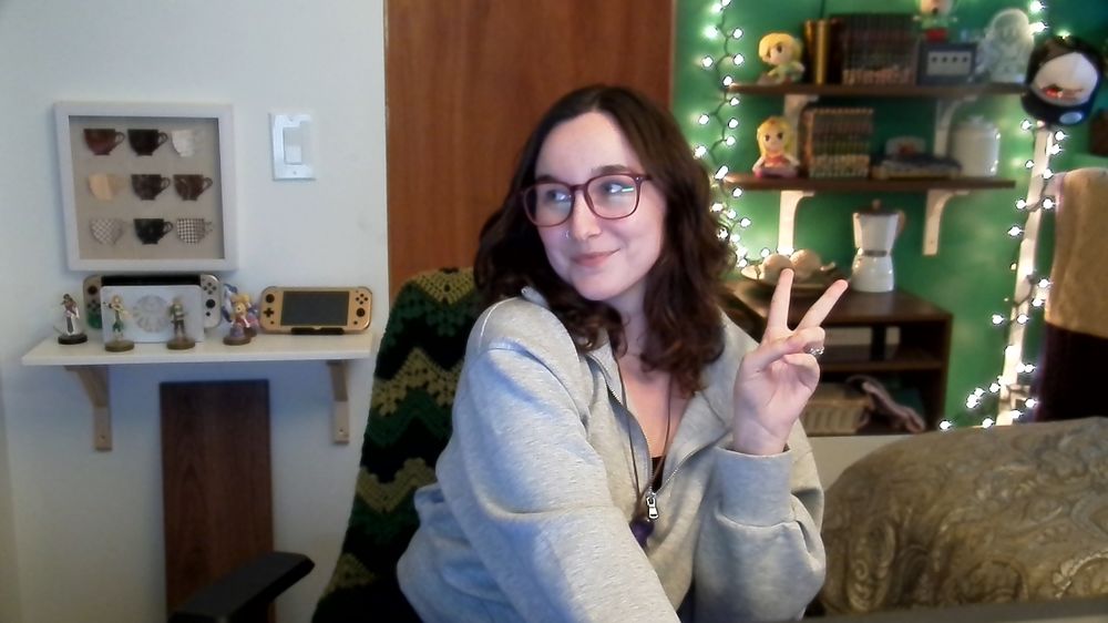 Lanaruse posing with a peace sign in front of her webcam in her new stream room.