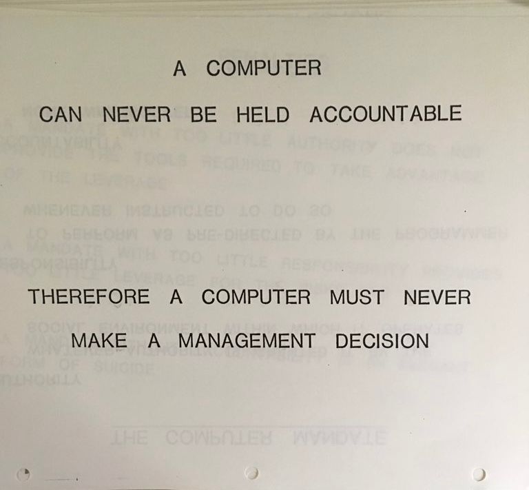 Page from IBM training binder, 1979. Only text on the page is all caps and ominously widely kerned, and reads: A COMPUTER CAN NEVER BE HELD ACCOUNTABLE / THEREFORE A COMPUTER MUST NEVER MAKE A MANAGEMENT DECISION