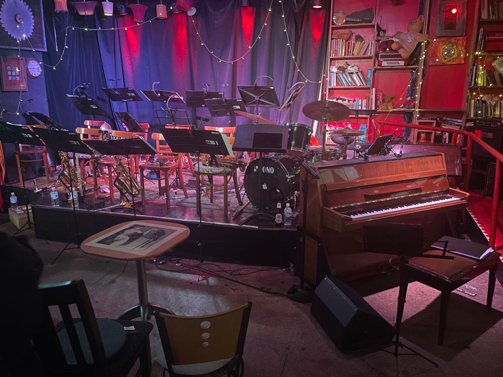 Stage set with music stands, drum kit & upright piano