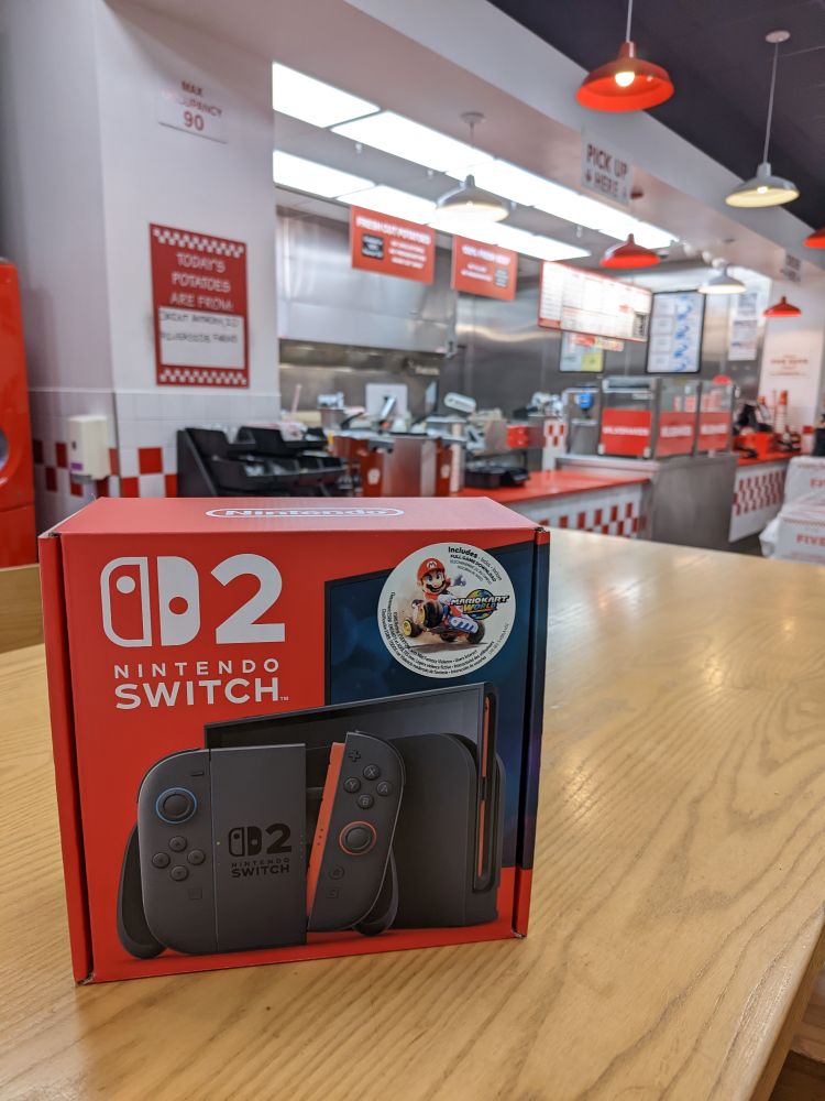 An in box Nintendo Switch 2 sitting on a table at Five Guys