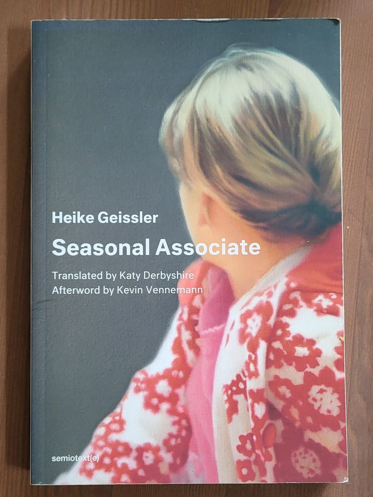 Book cover: "Heike Geissler / Seasonal Associate / Translated by Katy Derbyshire / Afterword by Kevin Vennemann / semiotext(e)" layed out over a photo-realistic painting by Gerhard Richter of a person with blond hair done in a bun looking away