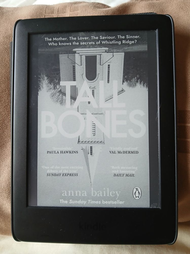 Kindle device showing the cover of 'Tall Bones' by Anna Bailey