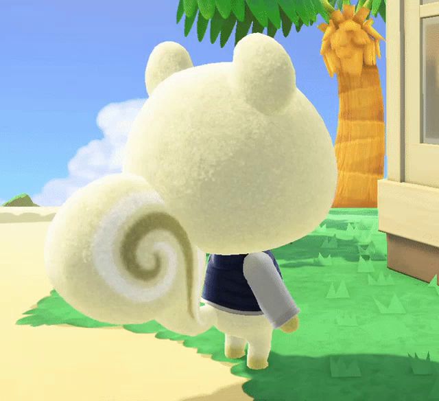 a stuffed animal with a swirl on its tail is standing in front of a house