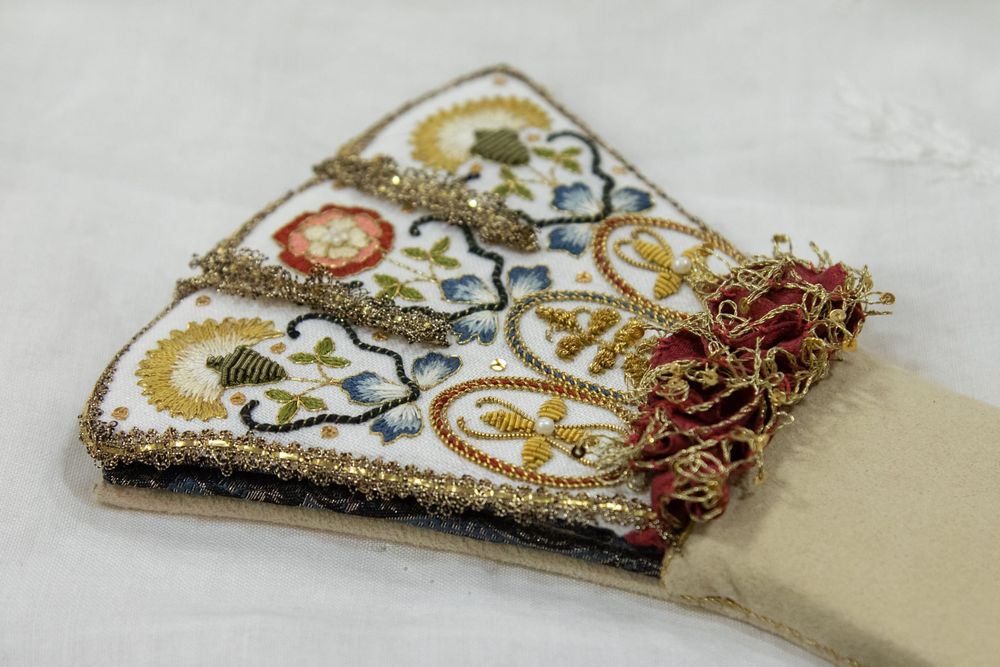 goldwork and colored embroidery on a sewing kit shaped like a renaissance glove.