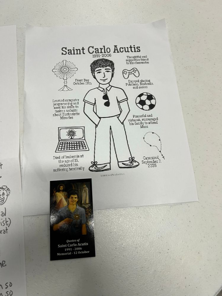 A saint’s card and coloring-book-style sheet of St Carlo Acutis, with various facts and images about him, including Nike swooshes on his shoes and mention of his love of Pokémon.