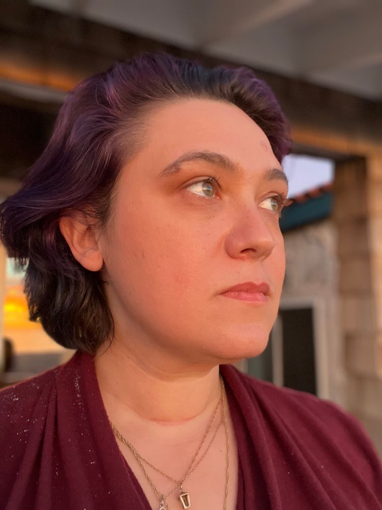 Em looks away from camera. No makeup, just the flattering light of sunset.