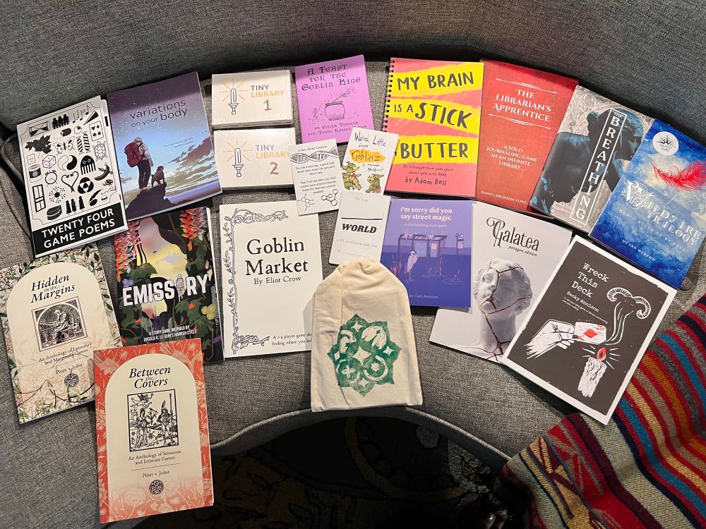 A spread of games, mostly in zine format 