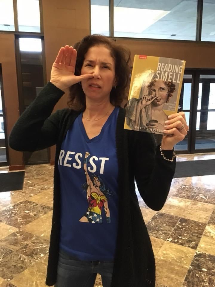 A woman pretends to take snuff