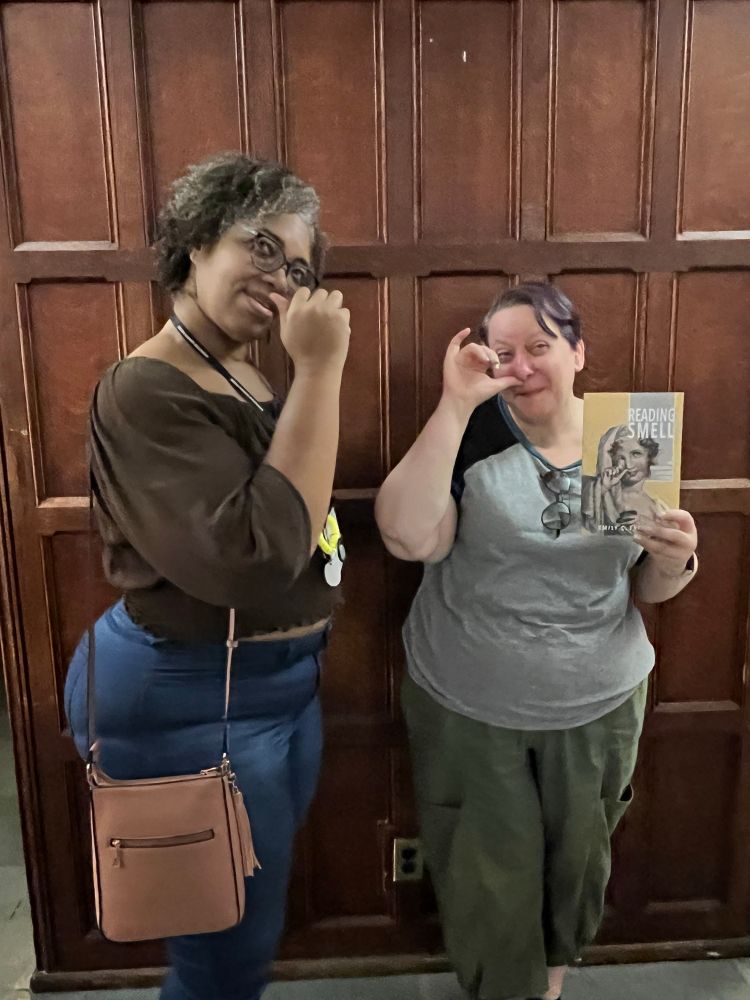 Two women pretend to take snuff