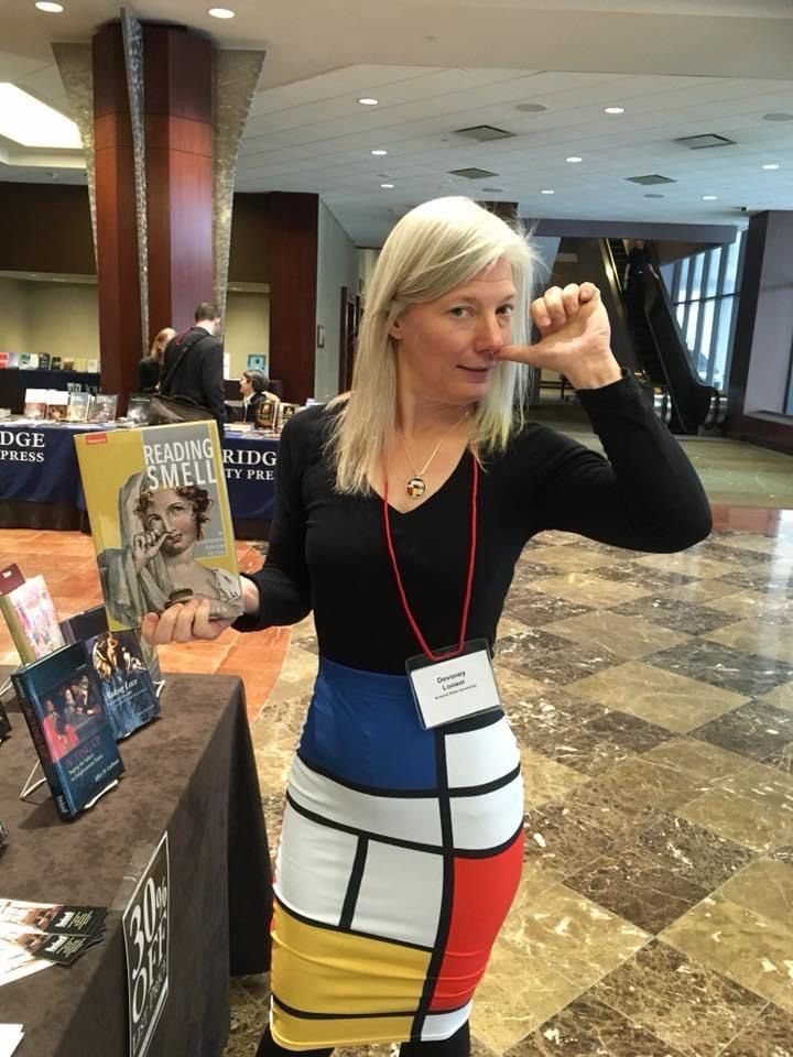 A woman pretends to take snuff