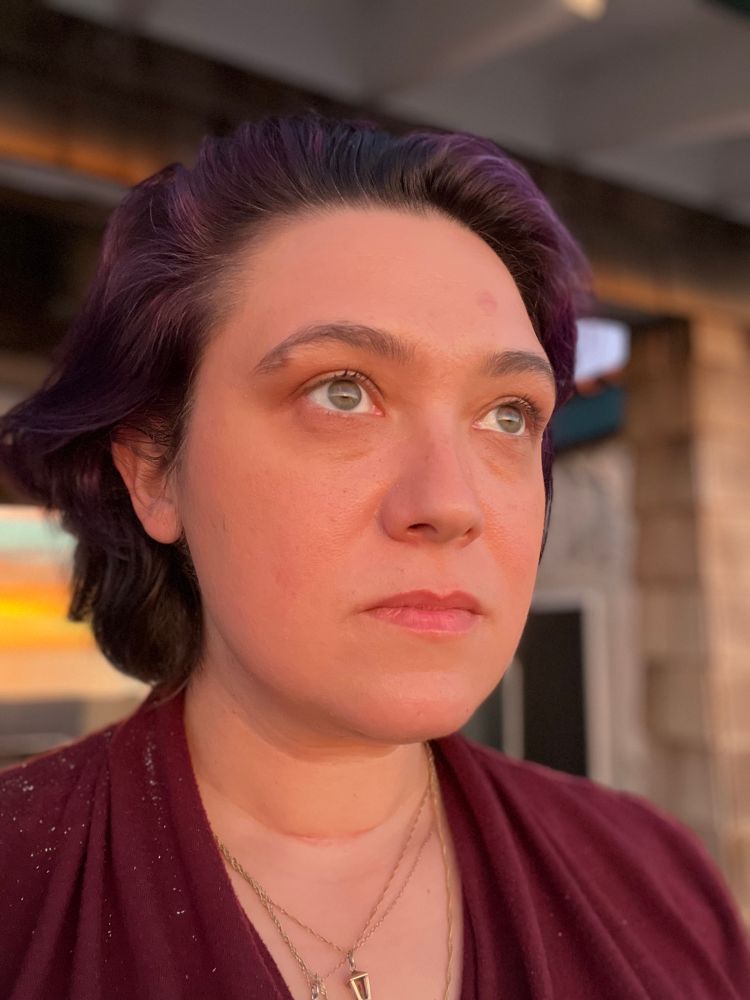 Em looks to horizon. No makeup, just the flattering light of sunset.